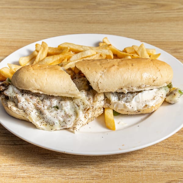 Two Red Snapper fish sandwiches with creamy sauce and black pepper, served with french fries.